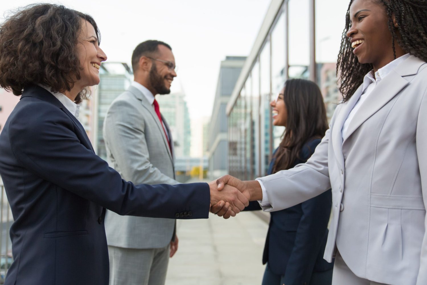 happy-confident-diverse-business-partners-meeting-city (1)